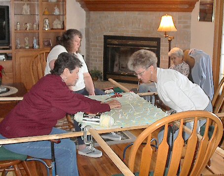 tying crib quilts for LDS Humanitarian